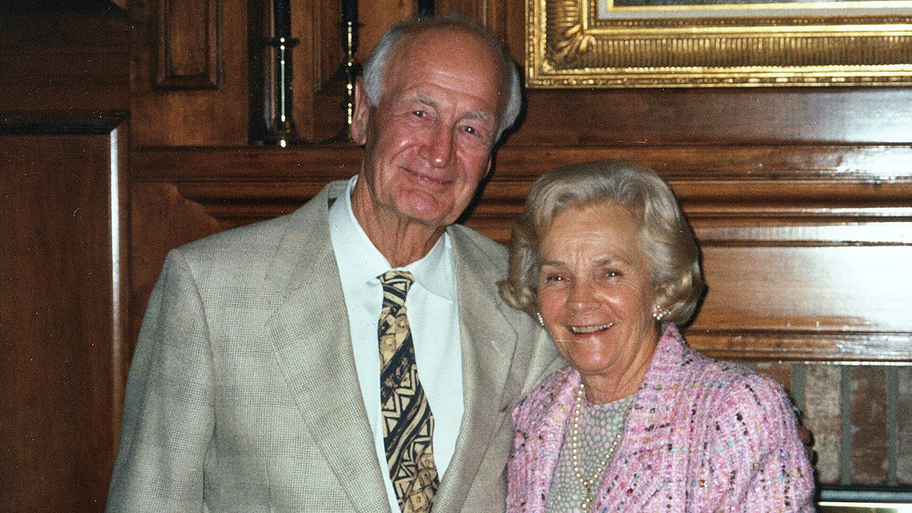 elderly female and male couple smiling at each other